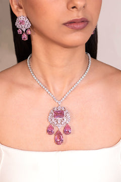Pink-sapphire CZ pendant necklace and matching earrings worn on a model – Duavaa