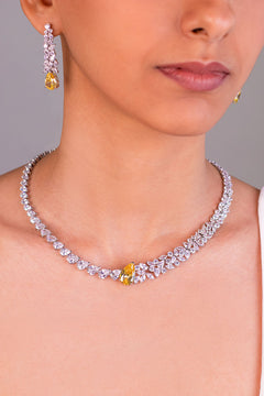 Yellow pear-cut crystal and white CZ necklace and drop earrings worn on neck and ear – Duavaa