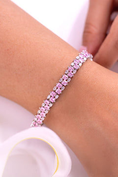 Pink stone tennis bracelet worn on a wrist with baguette accents – Duavaa