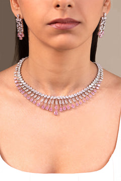 Pink pear-cut teardrop pendant necklace and drop earrings worn by model – Duavaa