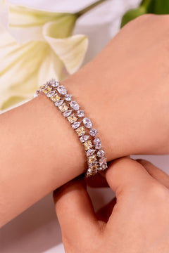 Yellow emerald-cut and crystal tennis bracelet worn on a wrist – Duavaa