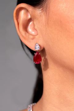 Ruby red teardrop drop earring with clear CZ stud worn on the ear – Duavaa