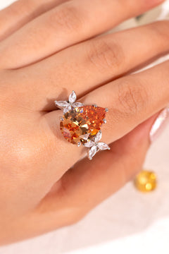Amber pear-cut crystal ring with marquise petal accents worn on hand, close-up – Duavaa