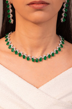 Green pear-cut stone necklace and earrings worn on neck and ear – Duavaa