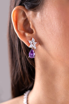 Crystal star cluster earring with purple pear-cut drop worn on ear – Duavaa