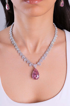 Pink pear-cut teardrop pendant necklace and earrings worn by model – Duavaa