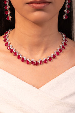 Red pear-cut stone necklace and earrings worn on neck and ear – Duavaa