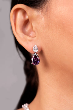 Purple pear-cut crystal drop earrings worn on the ear – Duavaa
