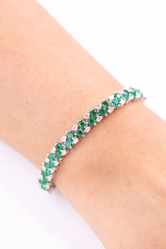 Green and clear CZ tennis bracelet worn on wrist, close-up – Duavaa