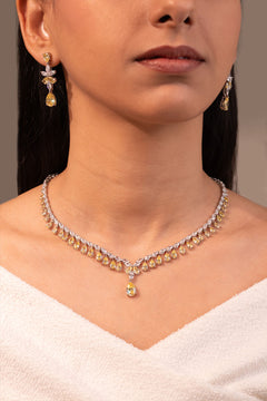 Yellow pear drop necklace with pendant and earrings worn on neck and ear – Duavaa