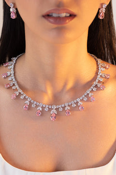 Pink teardrop CZ necklace with matching earrings worn by a model – Duavaa