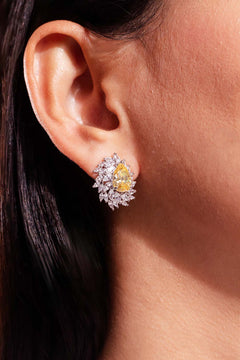 Yellow pear-cut crystal stud earring with marquise CZ halo worn on model's ear – Duavaa