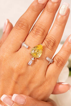 Yellow pear-cut crystal ring with baguette accents worn on the finger – Duavaa