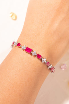 Ruby red mixed-cut tennis bracelet with crystal accents worn on wrist – Duavaa