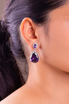 Purple teardrop crystal halo drop earring worn on a model's ear – Duavaa