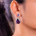 Purple teardrop crystal halo drop earring worn on a model's ear – Duavaa