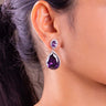 Purple teardrop crystal halo drop earring worn on a model's ear – Duavaa