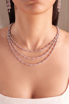 Pink and white three-strand layered necklace with spaced oval stones worn on model – Duavaa