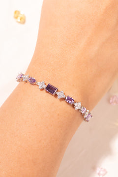 Purple mixed-cut tennis bracelet with crystal accents worn on a wrist – Duavaa