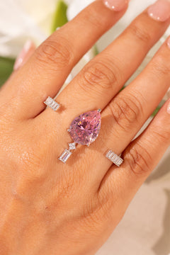 Pink pear-cut crystal ring with baguette accents worn on the finger – Duavaa