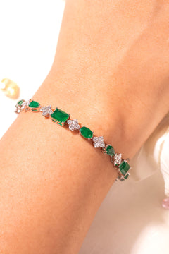 Green emerald-cut tennis bracelet with CZ flower clusters on wrist – Duavaa