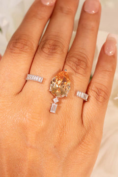 Champagne pear-cut crystal ring with baguette accents worn on the finger – Duavaa
