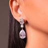 Clear crystal pear drop earring worn on a model's ear – Duavaa