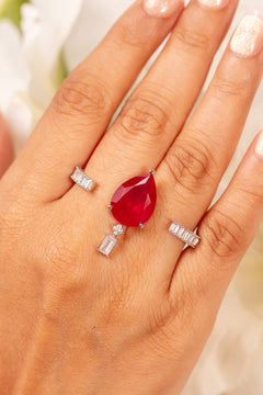 Ruby red pear-cut crystal ring with baguette accents worn on the finger – Duavaa