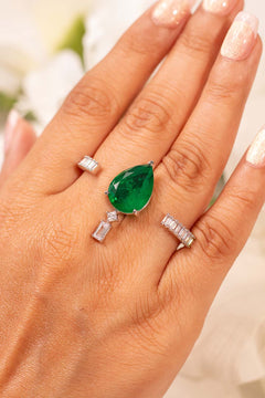 Emerald green pear-cut crystal ring with baguette accents worn on the finger – Duavaa