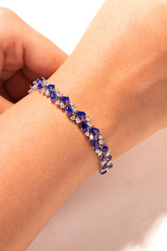 Blue pear-cut sapphire and crystal tennis bracelet worn on the wrist – Duavaa