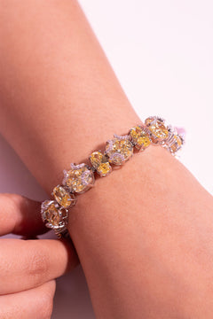 Yellow oval-cut tennis bracelet with crystal accents worn on the wrist – Duavaa