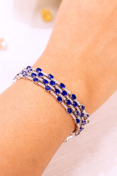 Blue multi-row oval-cut tennis bracelet worn on a wrist – Duavaa