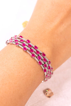 Ruby pink multi-row oval-cut tennis bracelet worn on a wrist – Duavaa
