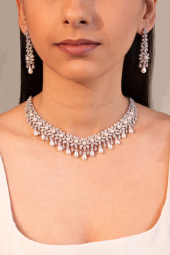 Silver-tone crystal and pearl floral necklace and drop earring set worn on model – Duavaa