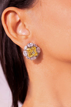 Close-up of yellow square-cut CZ halo stud earring worn on a model's ear – Duavaa