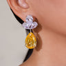 Golden yellow teardrop crystal drop earring worn on model's ear – Duavaa