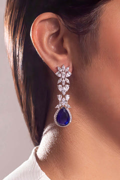 Sapphire blue pear-cut halo drop with white marquise floral links worn on model's ear – Duavaa