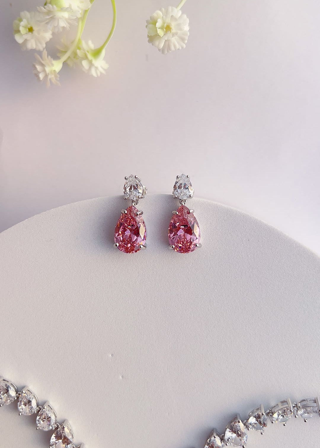 Pink pear-cut crystal drop earrings worn on the ear – Duavaa
