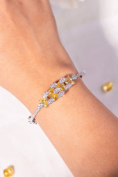 Yellow princess-cut bracelet with pavé crystal clusters worn on wrist – Duavaa